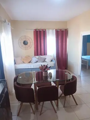 a living room with a table and a couch at ANGÉLICA RÉSIDENCE Centre-ville 350 m plage in Tarrafal