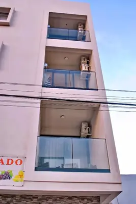 a building with two balconies on the side of it at Brisa Suites in Santa Maria