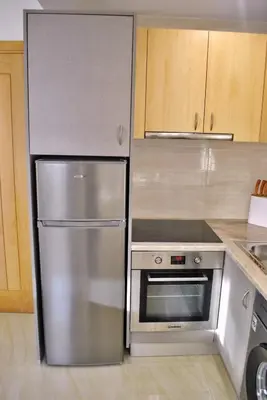 a stainless steel refrigerator and oven in a kitchen at Brisa Suites in Santa Maria