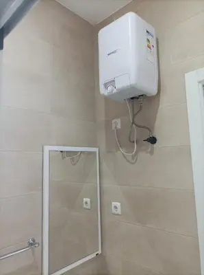 a shower in a bathroom with a mirror at LBranco in Porto Novo
