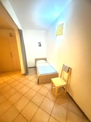 a room with a bed and a chair in it at near the beach On bedroom flat very good in Santa Maria