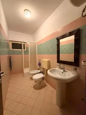 a bathroom with a sink and a toilet and a mirror at near the beach On bedroom flat very good in Santa Maria