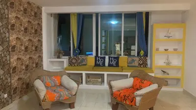 a living room with two chairs and a window at Beach Village Rest in Tarrafal