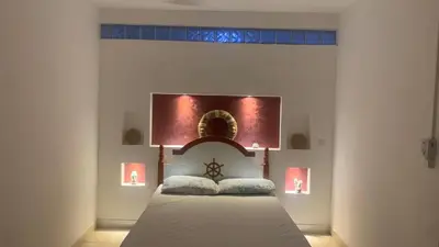a bedroom with a bed with a head board at Beach Village Rest in Tarrafal