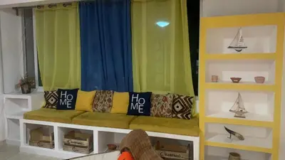 a living room with a bench in a window at Beach Village Rest in Tarrafal