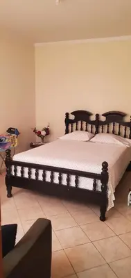 a bedroom with a large bed in a room at Apart savane Fogo in São Filipe
