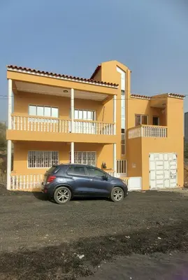 a car parked in front of a house at Apart savane in São Filipe