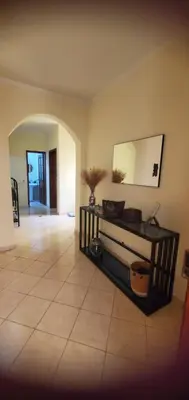 a living room with a mirror and a tile floor at Apart savane in São Filipe