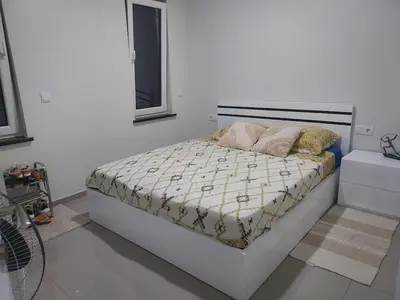 a bed with two pillows on it in a bedroom at Appartement Vue Mer in Mindelo