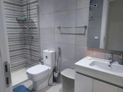 a bathroom with a toilet and a sink and a shower at Appartement Vue Mer in Mindelo
