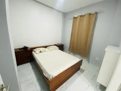 a small bedroom with a bed and a shower at Apartamento T2 mobiliado in Mindelo