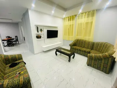 a living room with two couches and a tv at Apartamento T2 mobiliado in Mindelo