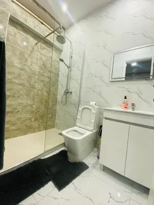 a bathroom with a shower and a toilet and a sink at Apartamento T2 mobiliado in Mindelo
