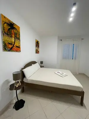 a bedroom with a bed and a chair in it at Larriba Santa Maria by RPG Group in Santa Maria