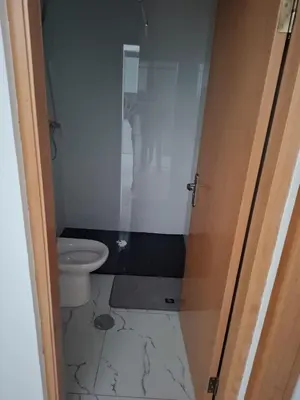 a bathroom with a toilet and a glass door at Casa do Céu Azul in Tarrafal