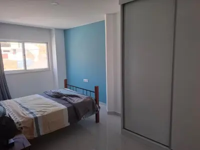 a bedroom with a bed and a window and a mirror at Tdois in Praia