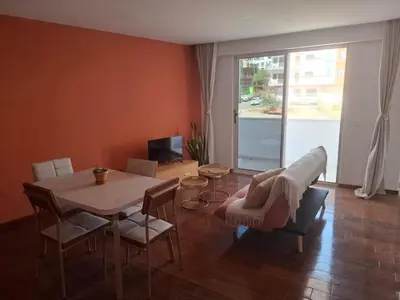 a living room with a table and a couch at Tdois in Praia