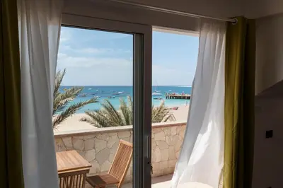 a view of the beach from a room with a sliding glass door at Villa ao Mar in Santa Maria