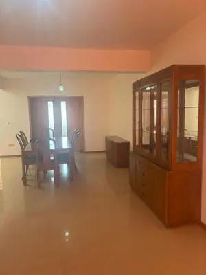 a dining room with a table and chairs and a cabinet at Ocean of View in Mindelo