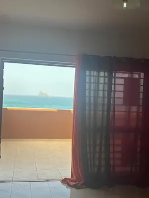 a room with a window with a view of the ocean at Ocean of View in Mindelo