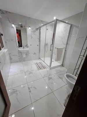 a white bathroom with a shower and a toilet at Casa América in Praia