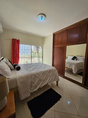 a bedroom with a bed and a large mirror at Casa América in Praia