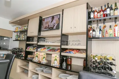 a room with a counter with many bottles of alcohol at Hotel Cesaria in Praia