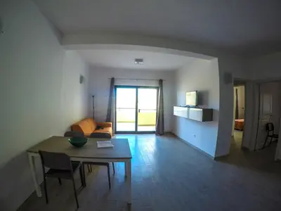 a living room with a table and a couch at Surf House Cabo Verde in Santa Maria