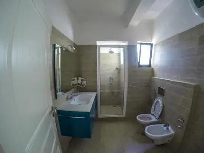 a bathroom with a sink and a toilet and a shower at Surf House Cabo Verde in Santa Maria