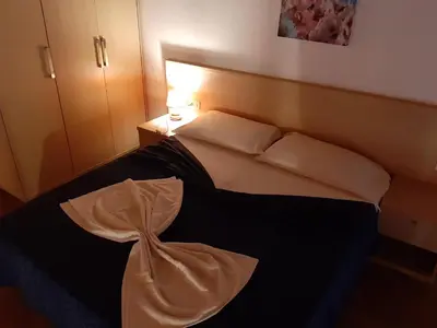 a hotel room with a bed with a dress on it at Aparthotel Ponta Preta in Santa Maria