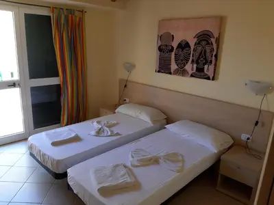 a hotel room with two beds and a window at Aparthotel Ponta Preta in Santa Maria