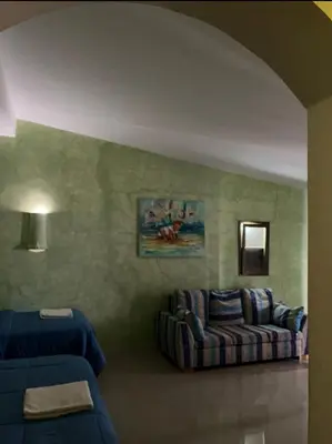 a living room with a couch and a chair at Vivenda Viviani in Praia