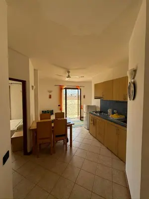 a kitchen with a table and a dining room at Pedra do Sol Praia Estoril Sal Rei FREE WI-FI in Sal Rei