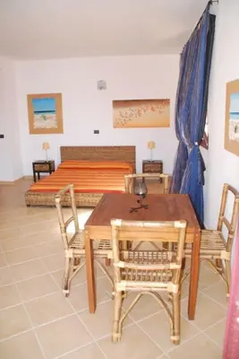 a room with a table and chairs and a bed at Holiday Properties Oleandro Ocean in Santa Maria