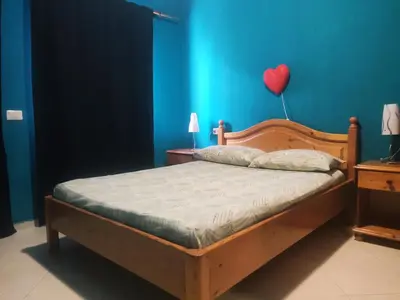 a bedroom with a bed with a heart balloon on the wall at Ca' Francisca in Santa Maria