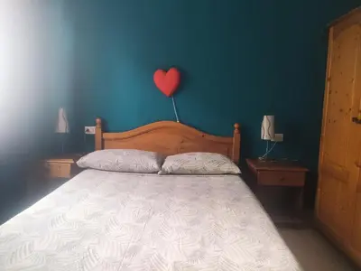 a bedroom with a bed with a heart on the wall at Ca' Francisca in Santa Maria