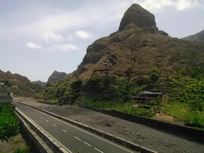 an empty road with a mountain in the background at Damontanha in Ribeira Grande