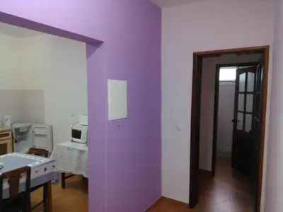 a room with a purple wall and a door at Damontanha in Ribeira Grande