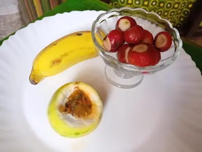 a plate with a bowl of fruit and a banana at Black Mamba in Paul