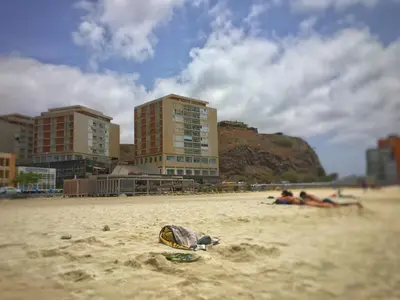 a group of people laying in the sand on a beach at Suite Mariposa Sospesa Sul Mare in Mindelo