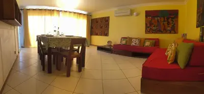 a living room with a table and a couch at Suite Mariposa Sospesa Sul Mare in Mindelo