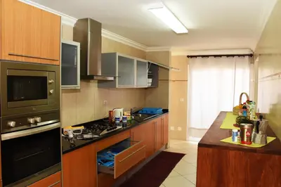 a kitchen with wooden cabinets and a stove top oven at Suite Mariposa Sospesa Sul Mare in Mindelo
