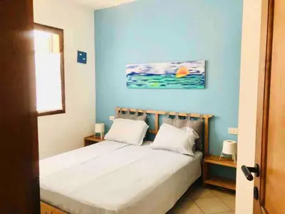 a bedroom with a bed with a blue wall at Two bedrooms, WIFI, near beach - Ca Greta in Sal Rei