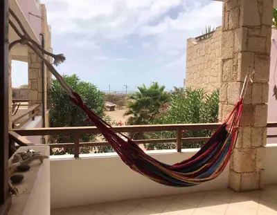 a hammock on a balcony with a view at Two bedrooms, WIFI, near beach - Ca Greta in Sal Rei