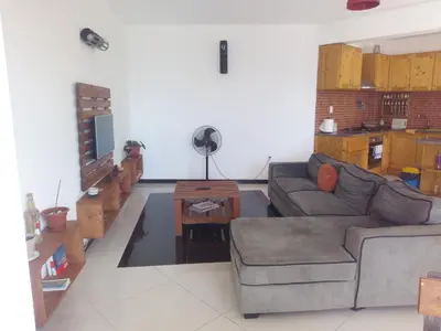 a living room with a couch and a table at Appart Chris Mindelo in Mindelo