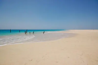 a group of people standing in the water on a beach at Villa Maris Ecolodge in Morro