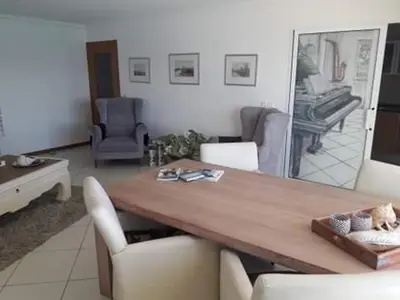 a dining room with a wooden table and chairs at @Georgette in Mindelo
