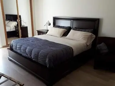 a bedroom with a large bed and a mirror at @Georgette in Mindelo