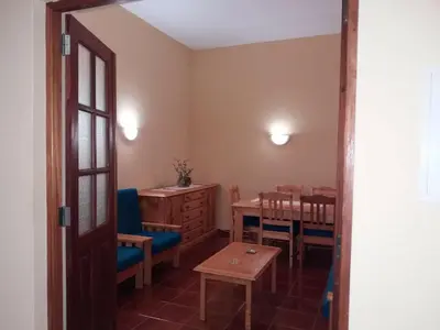 a room with a table and chairs and a dining room at Ribeira Grande Country House in Escabeçada
