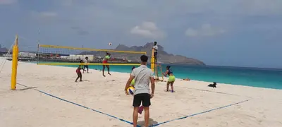 a group of people playing volleyball on the beach at Laginha Beach Guest House in Mindelo